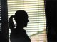 woman standing by window silhouette