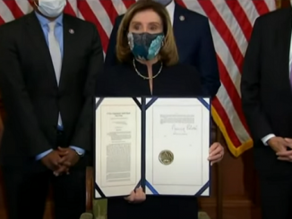 Nancy Pelosi holds the signed impeachment article