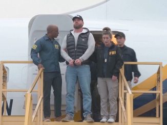 Ryan Wedding leaves plane escorted by the FBI