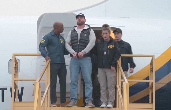 Ryan Wedding leaves plane escorted by the FBI