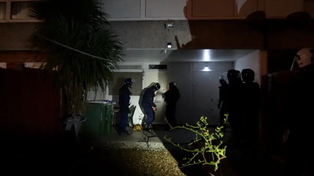 police raid a home in London connected with romance fraud